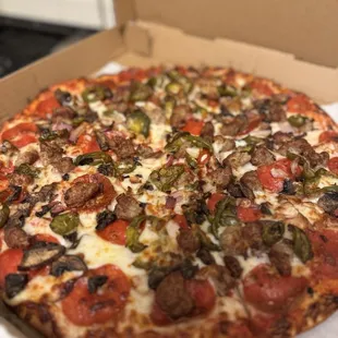 Carnivore pizza with jalapeños, thin crust, well done