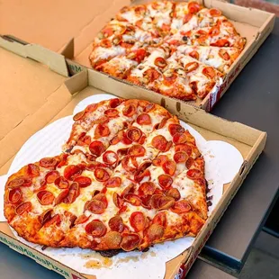 two pizzas on a table