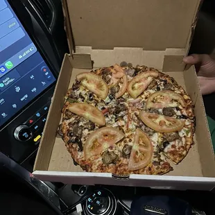 Small 10&quot; Italian sausage, Beef, onions, bell pepper, mushrooms, black olives, extra cheese topped with fresh tomato slices.