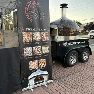 a pizza truck with a pizza oven