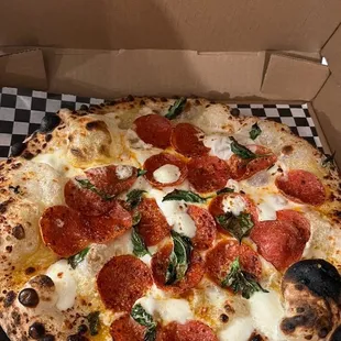 a pepperoni pizza in a box