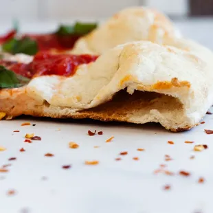 a slice of pizza with a bite taken out of it