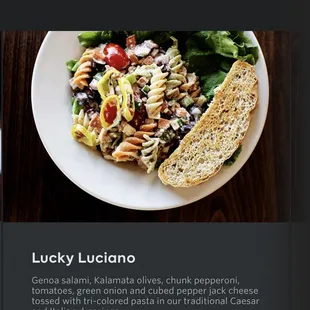a plate of pasta and a piece of bread