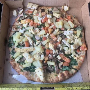 Vegan customized pizza: tofu, pineapple, spinach, mushrooms, tomatoes