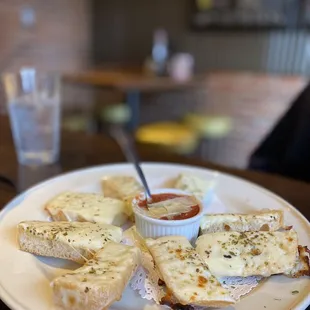a plate of bread and dipping sauce
