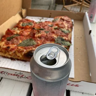 a box of pizza and a can of soda