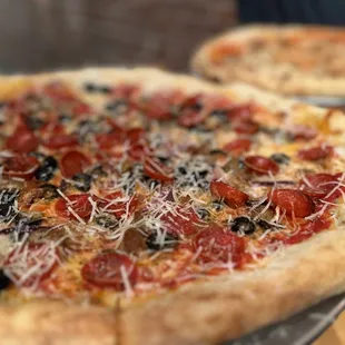 two pizzas on a table