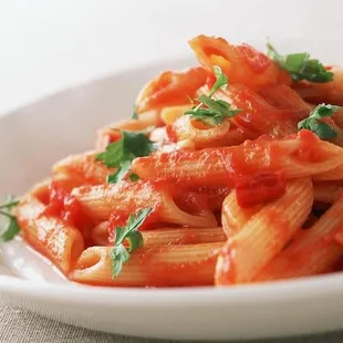 a plate of pasta with tomato sauce