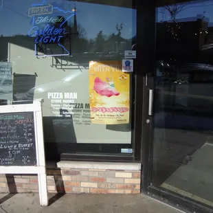 Front entry door and sidewalk sandwich board.
