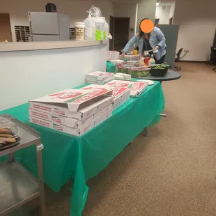 pizza boxes on a table in an office