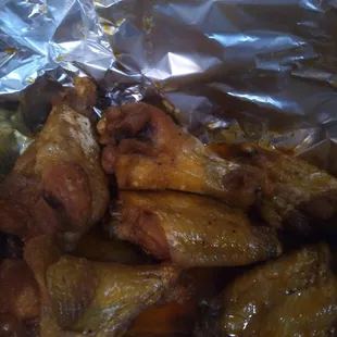 chicken wings and broccoli wrapped in foil