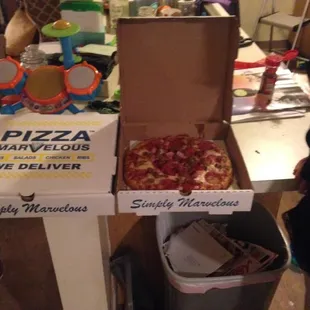 two boxes of pizza on a table