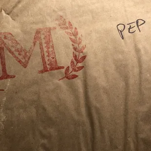 a piece of paper with the letter m on it