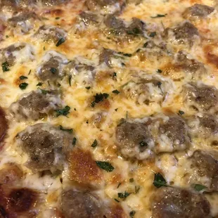 a pizza with meatballs and cheese