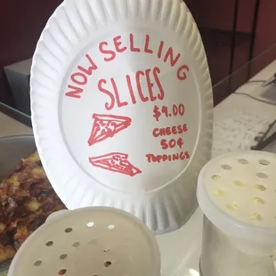 a paper plate with a slice of pizza on it