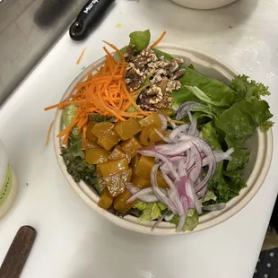 two bowls of salad on a counter