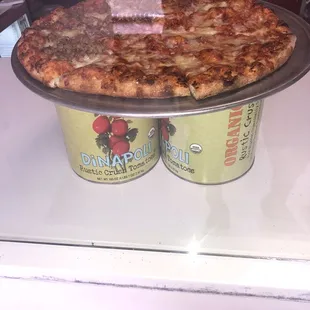 two cans of pizza on a counter