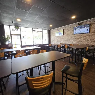 Sitting at back tables facing the door, 5 tv's in total in here