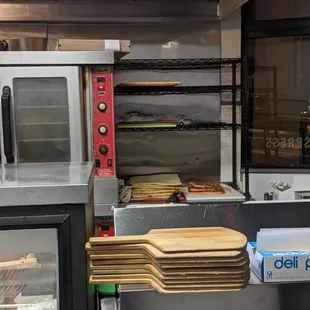 a pizza oven with pizzas in it