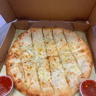 a pizza in a box with sauces