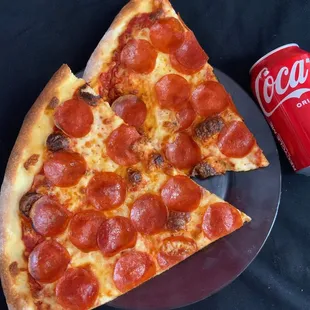 a slice of pepperoni pizza and a coke