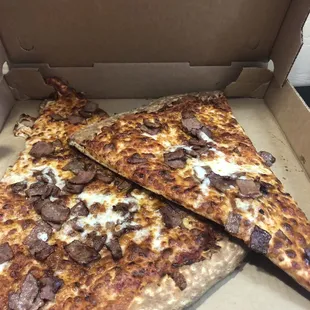 Two slices of pizza was bacon.
