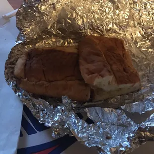 a piece of a sandwich wrapped in tin foil