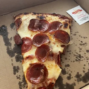 Pizza by the slice. The pepperonis curl and make my taste buds sing.