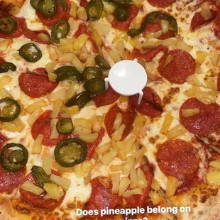 Pepperoni pizza and pineapple pizza half jalapeños