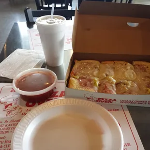 a box of pizza and a cup of coffee