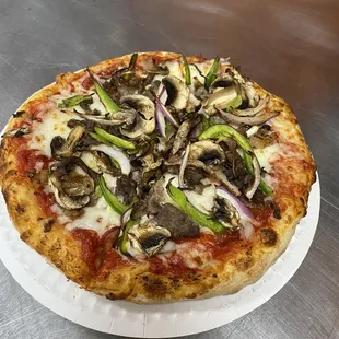 a pizza on a paper plate