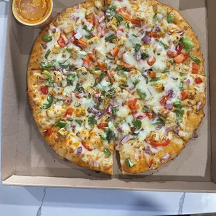 Chicken tikka pizza. Beautiful presentation w butter sauce on side