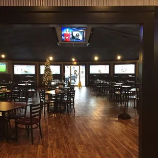 Family area behind the bar with loads of TVs.