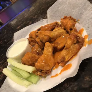a plate of chicken wings and celery