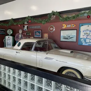 a man standing next to a white car