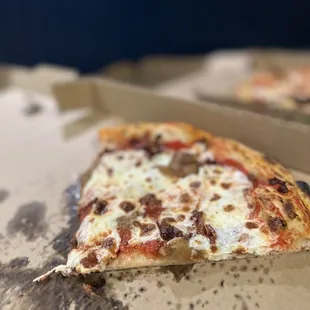 a slice of pizza in a box