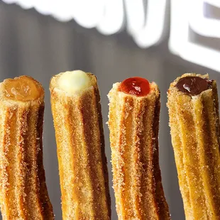 a row of churros in front of a sign