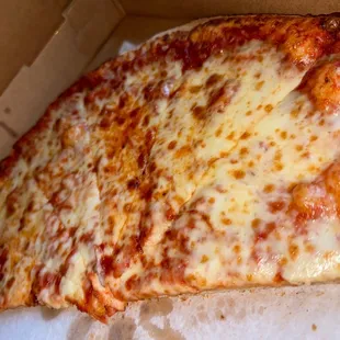 a slice of cheese pizza in a box