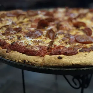a pepperoni pizza on a table