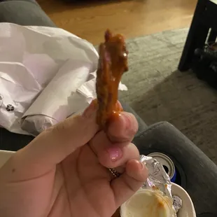 a person holding a piece of food