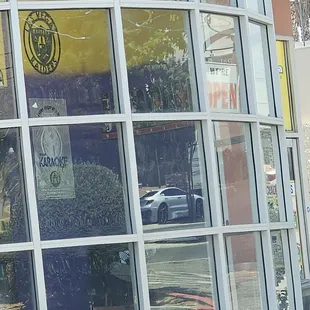 Front window with open sign but locked doors