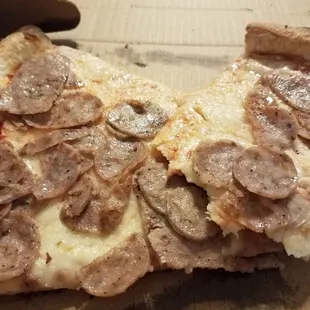 Thin, greasy, floppy pizza.