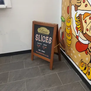 a sign for slices of pizza