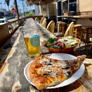 a plate of pizza and a glass of beer