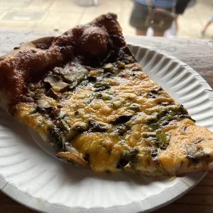 a slice of pizza on a paper plate