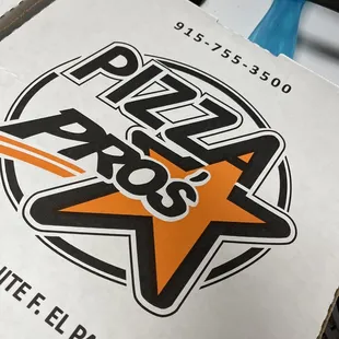 a pizza box on a stove