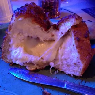 a half eaten sandwich on a blue plate