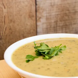 a bowl of soup on a wooden table