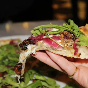 The Duck &amp; Fig pizza was made with confit duck leg, port pickled red onion, fig, arugula and fresh mozzarella.