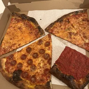 four slices of pizza in a box